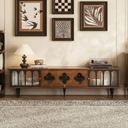 Wooden entertainment console with decorative items in a living room setting